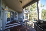 Deck with hot tub, seated dining for four, barbeque, nestled in the trees with view